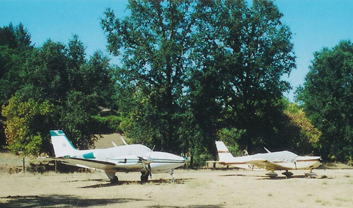 Planes tied down, off the landing strip